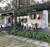 Absolute riverfront shipping container cabin - Redcliffe Tourism